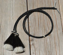 Close Up View natural horse hair Stampede String with two bell mule tail cut tassels and cotter pin attachments.     Black/Black/White