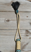 Close Up View Beautiful Jose Ortiz Braided Rawhide Quirt Whip with Hitched Horsehair Knots and Hand Tooled Leather Popper. Natural colored rawhide with turquoise blue and black details. 