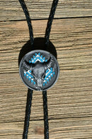 Super Close Up View Western Style Black Braided Leather Bolo Tie with beautifully detailed steer skull slide in grey and matt black and turquoise southwest enamel design. 