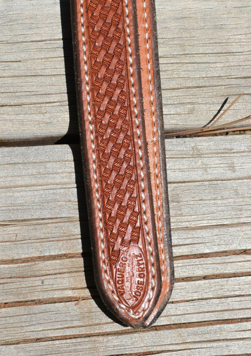 Super Close Up View Beautiful Jose Ortiz Braided Rawhide Quirt Whip with Hitched Horsehair Knots and Hand Tooled Leather Popper. Natural colored rawhide with turquoise blue and black details. 