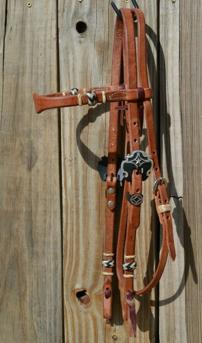 Jose Ortiz 5/8" Shape Browband Headstall.  Constructed of super soft conditioned natural harness leather.  Jose's signature natural hand braided rawhide with black details on cheek pieces and browband.