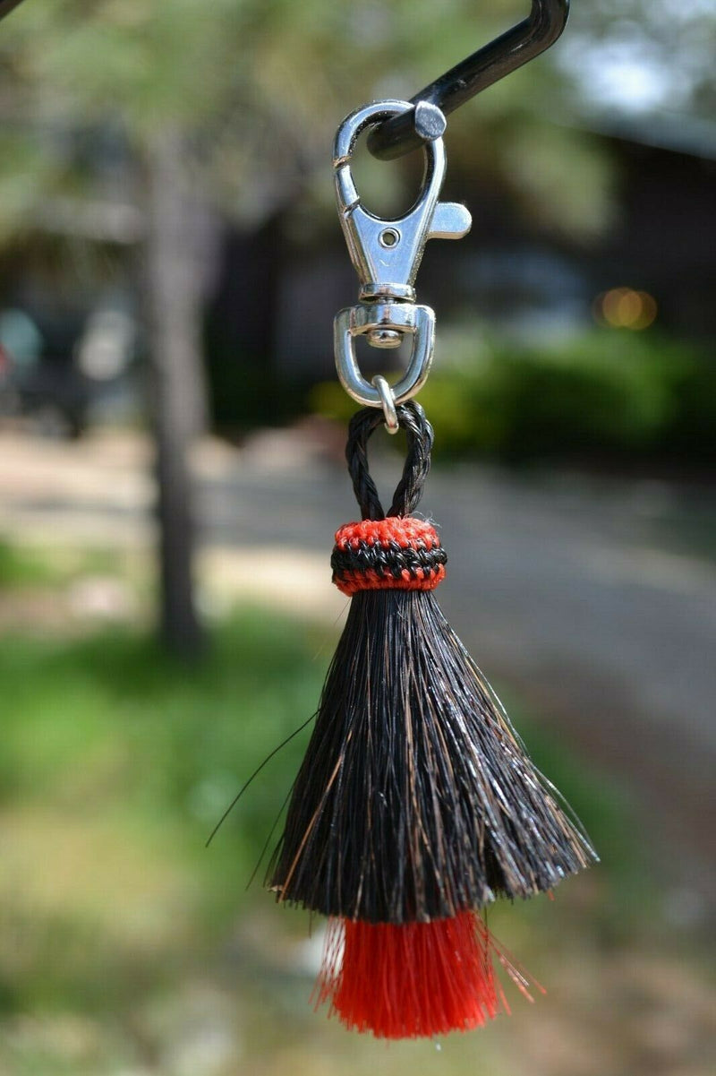 Close Up View 4.25" total length natural horsehair zipper pull with Larger Clasp. Handmade horsehair in the two bell mule tail style.     Black/Red