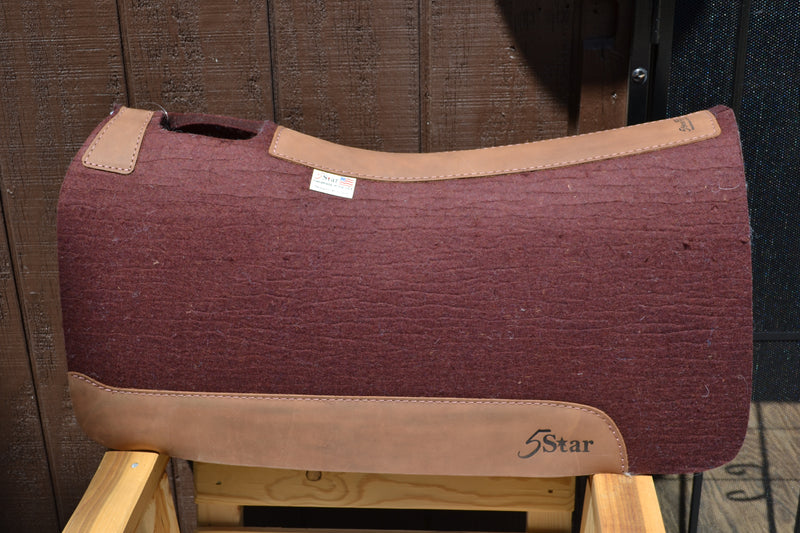 The Roper 5 Star Saddle Pad is our wide pad. It is a great pad for Roping, Ranching, Trail Riding, and Shorter Saddles. The 100% pure virgin wool felt wicks away moisture, cleans up easily and stabilizes your saddle with limited cinching. Wear leathers provide protection and durability