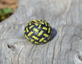 Close up View Hand braided rawhide scarf slide.  Custom made in two-tone combinations of black and bright colored leather braided in a custom "checkerboard" pattern.    Lime/Black