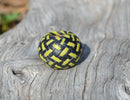 Close up View Hand braided rawhide scarf slide.  Custom made in two-tone combinations of black and bright colored leather braided in a custom "checkerboard" pattern.    Lime/Black