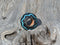 Hand braided rawhide scarf slide.  Custom made in two-tone combinations of black and bright colored leather braided in a "zig zag" pattern.    Turquoise/Black