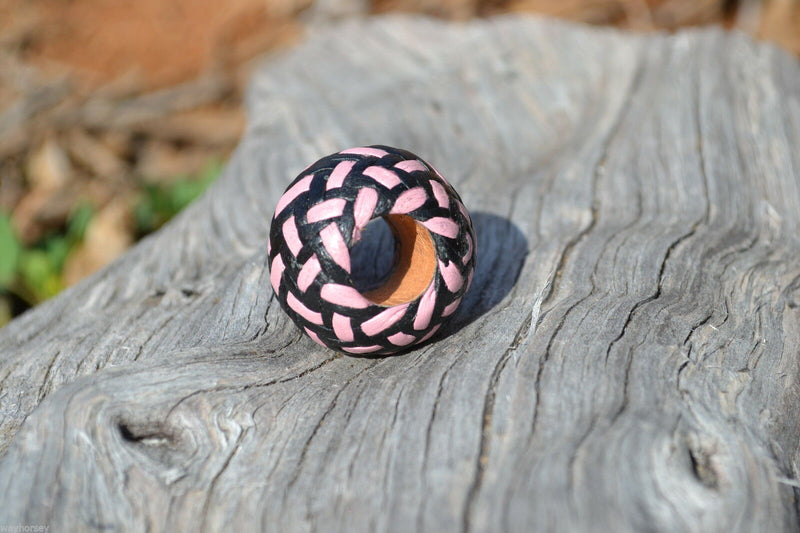 Close up View Hand braided rawhide scarf slide. Custom made in two-tone combinations of black and bright colored leather braided in a custom "checkerboard" pattern.    Pink/Black