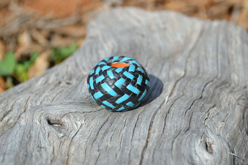 Close up View Hand braided rawhide scarf slide. Custom made in two-tone combinations of black and bright colored leather braided in a custom "checkerboard" pattern.   Turquoise/Black