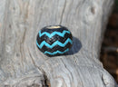 Hand braided rawhide scarf slide.  Custom made in two-tone combinations of black and bright colored leather braided in a "zig zag" pattern.Turquoise/Black